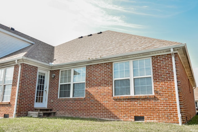 view of side of property with a yard