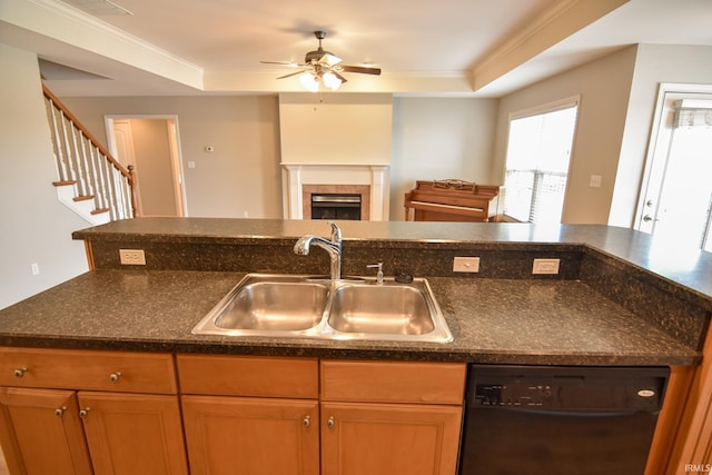 kitchen with a tile fireplace, ornamental molding, black dishwasher, and sink