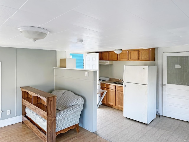 kitchen featuring white appliances and sink