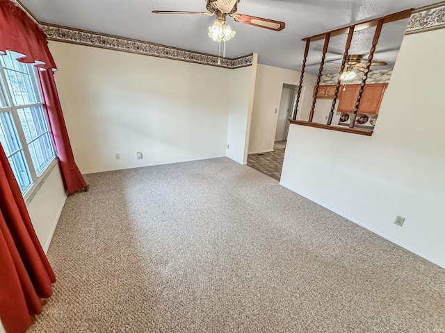 unfurnished room featuring ceiling fan and carpet flooring