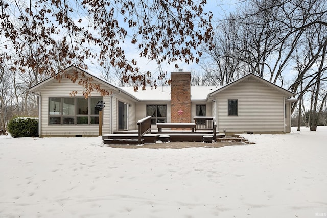 snow covered property featuring a wooden deck