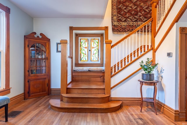 staircase with wood-type flooring