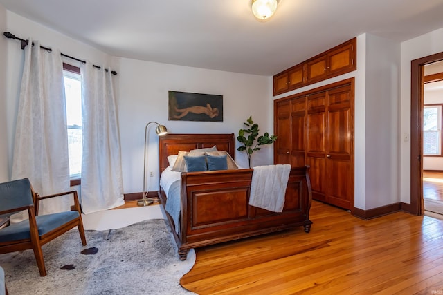 bedroom with light hardwood / wood-style flooring and a closet