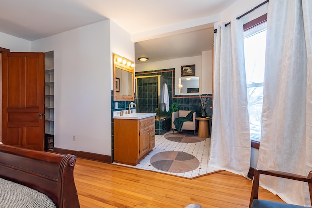 bathroom featuring hardwood / wood-style floors, vanity, and tile walls