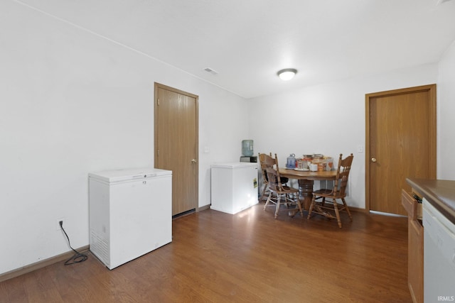 dining area with dark hardwood / wood-style flooring