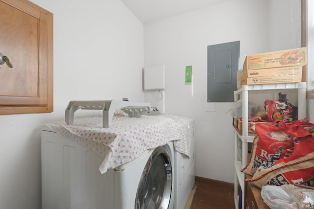 laundry room featuring dark wood-type flooring, electric panel, and washer and clothes dryer