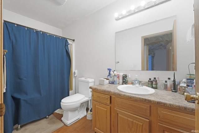 bathroom featuring hardwood / wood-style flooring, vanity, and toilet