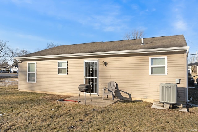 back of property with cooling unit, a yard, and a patio