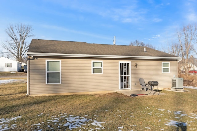 rear view of property featuring a patio and a lawn