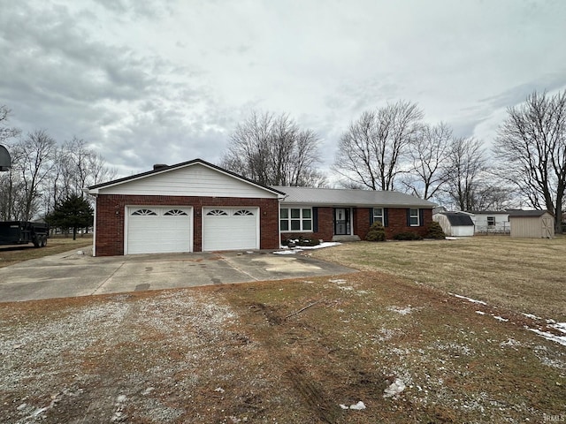 ranch-style home featuring a storage shed, a garage, and a front yard