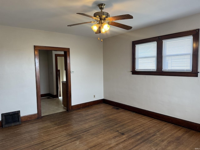 unfurnished room with dark hardwood / wood-style flooring and ceiling fan