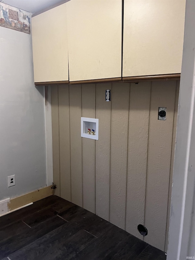 washroom featuring dark wood-type flooring, cabinets, washer hookup, and electric dryer hookup