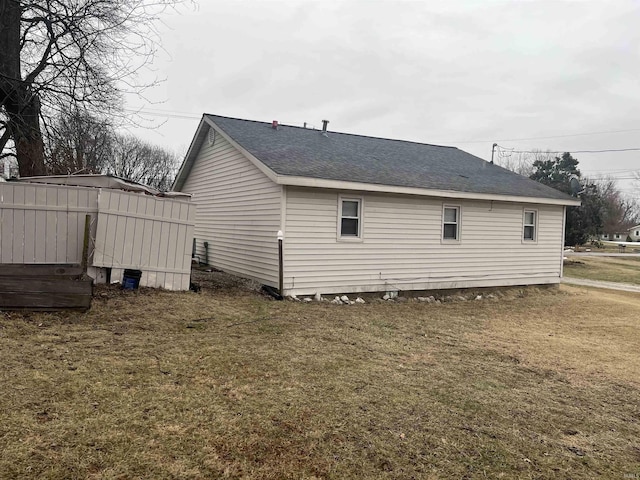 view of side of home featuring a lawn