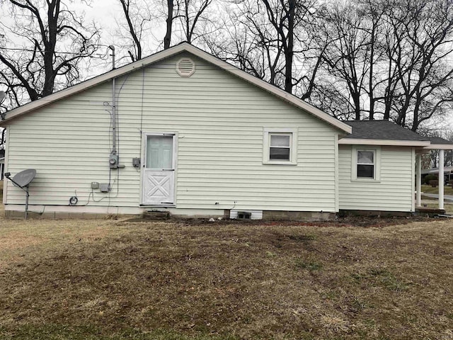 rear view of property featuring a yard