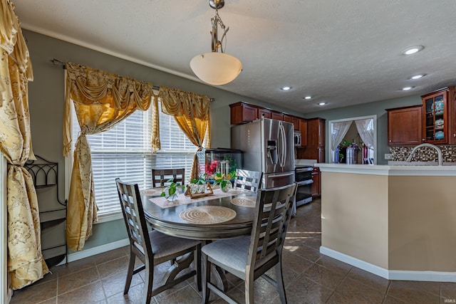 dining room featuring sink and a textured ceiling