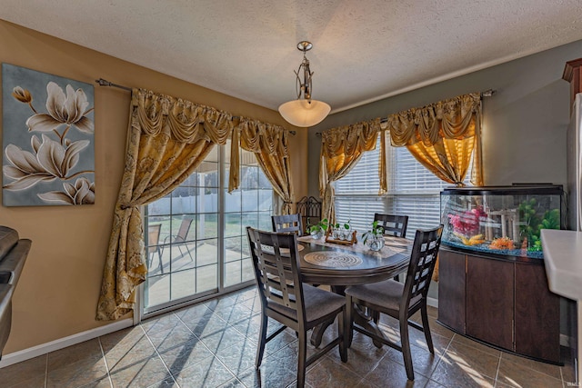 dining space with a textured ceiling