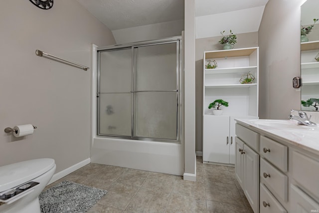 full bathroom featuring tile patterned floors, toilet, a textured ceiling, vanity, and enclosed tub / shower combo