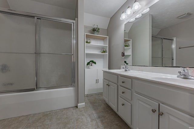 bathroom with tile patterned flooring, vanity, a textured ceiling, and shower / bath combination with glass door