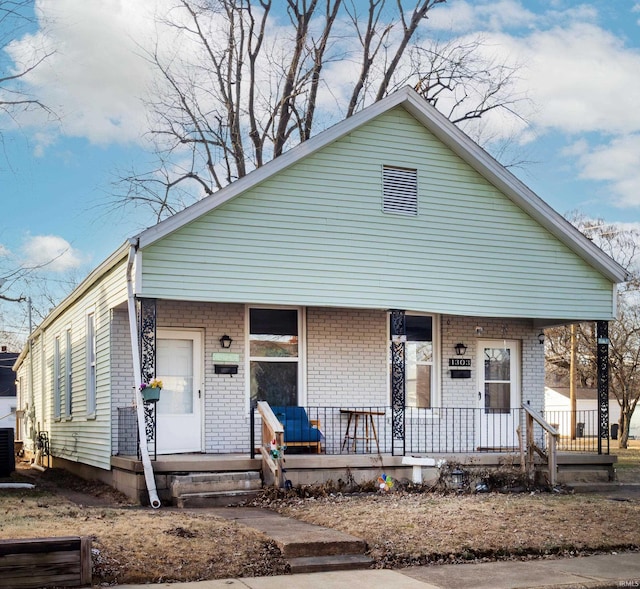 bungalow-style house with covered porch and central air condition unit