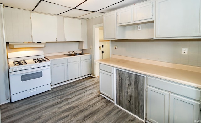 kitchen featuring dark hardwood / wood-style flooring, white gas range, sink, and white cabinets