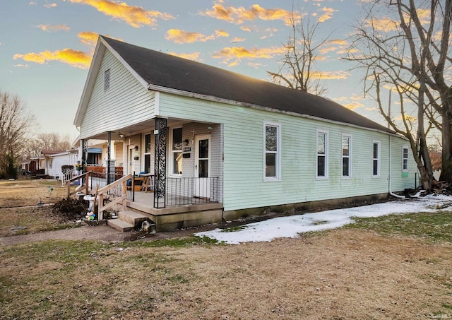 view of front of house featuring a yard and covered porch