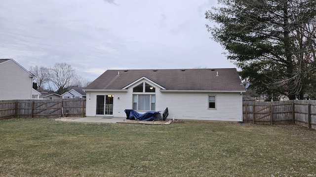 back of house featuring a patio and a yard