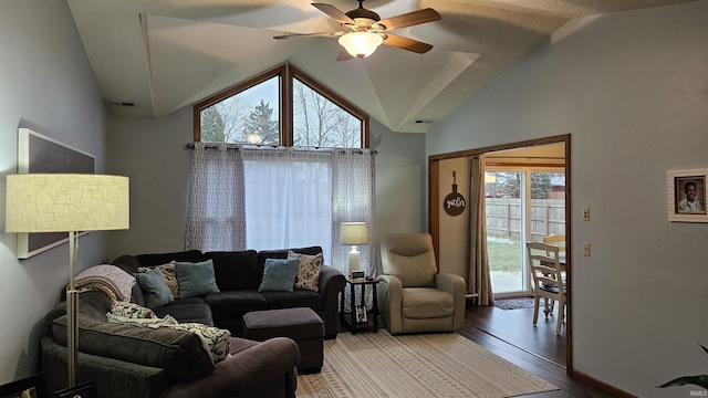 living room with ceiling fan, plenty of natural light, high vaulted ceiling, and wood-type flooring