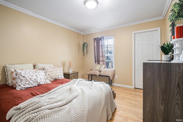 bedroom with crown molding and light hardwood / wood-style flooring