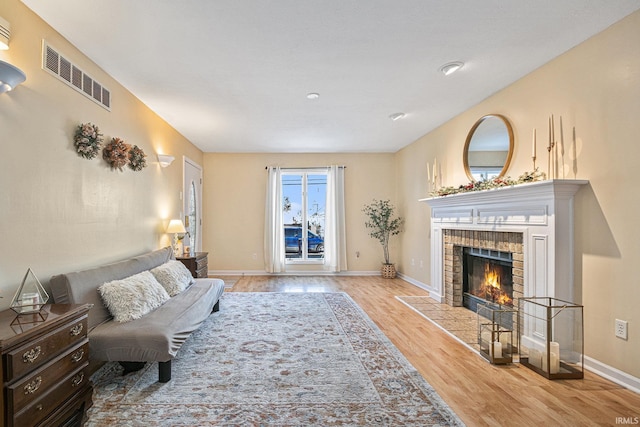 living room featuring a fireplace and light hardwood / wood-style flooring