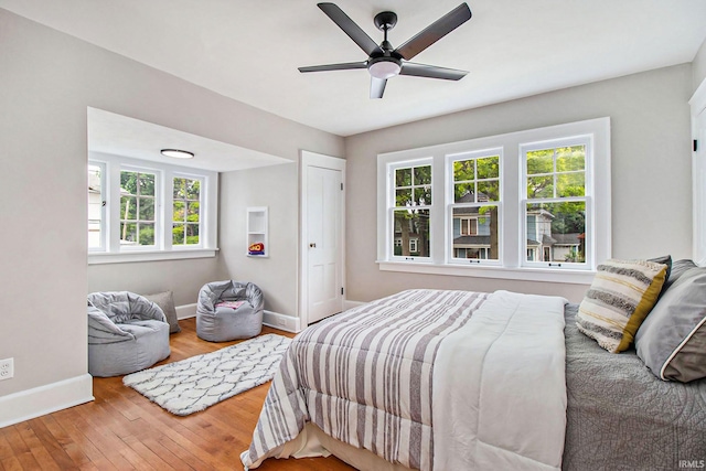 bedroom with hardwood / wood-style flooring and ceiling fan