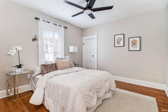 bedroom with hardwood / wood-style flooring and ceiling fan