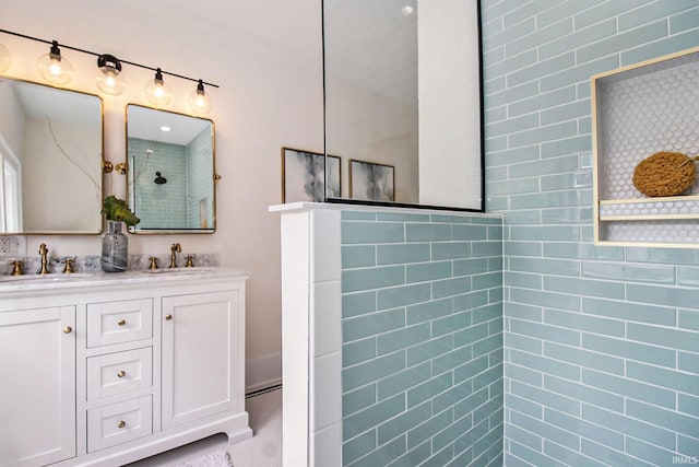 bathroom with vanity and tiled shower