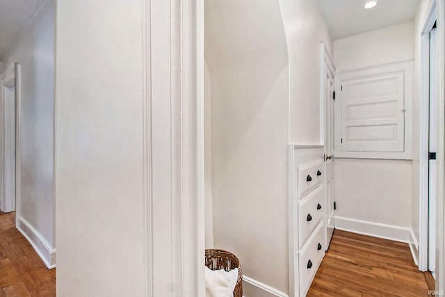 corridor with hardwood / wood-style flooring