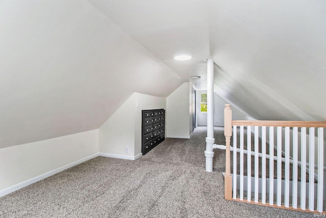 additional living space featuring carpet floors and vaulted ceiling