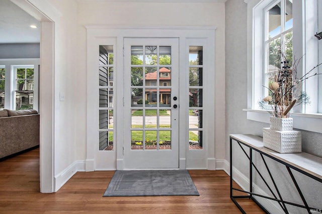 entryway with dark hardwood / wood-style flooring