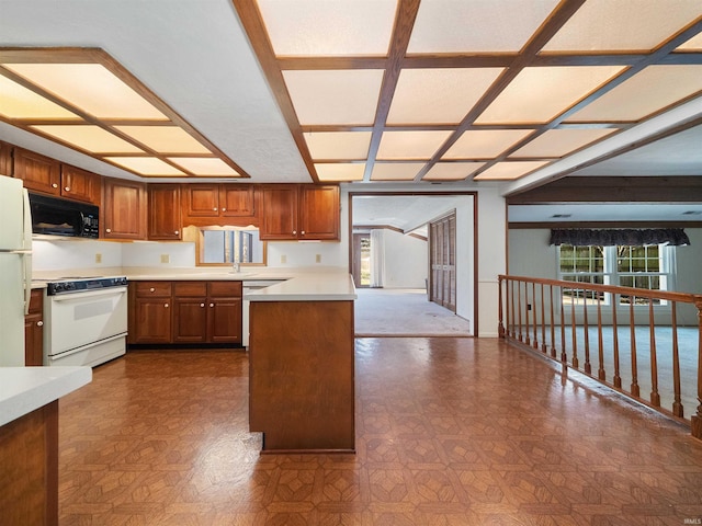 kitchen featuring white appliances and kitchen peninsula