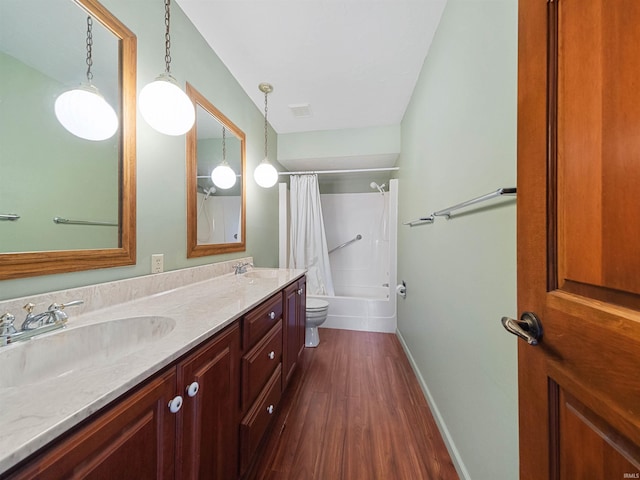 full bathroom featuring shower / bathtub combination with curtain, hardwood / wood-style floors, vanity, and toilet