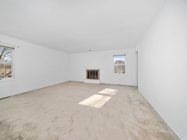 unfurnished living room with light colored carpet