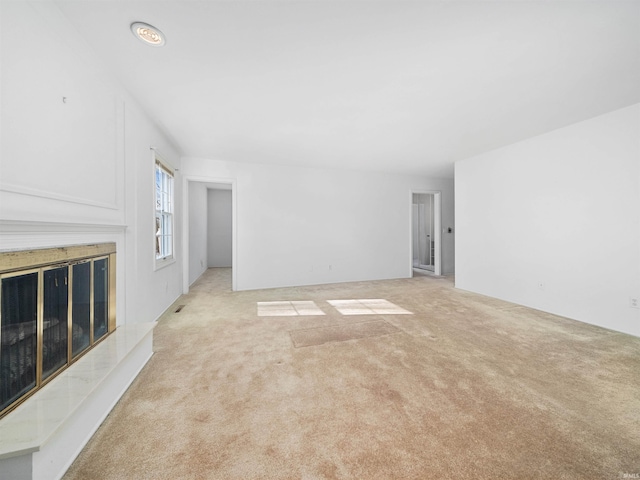 unfurnished living room with light colored carpet