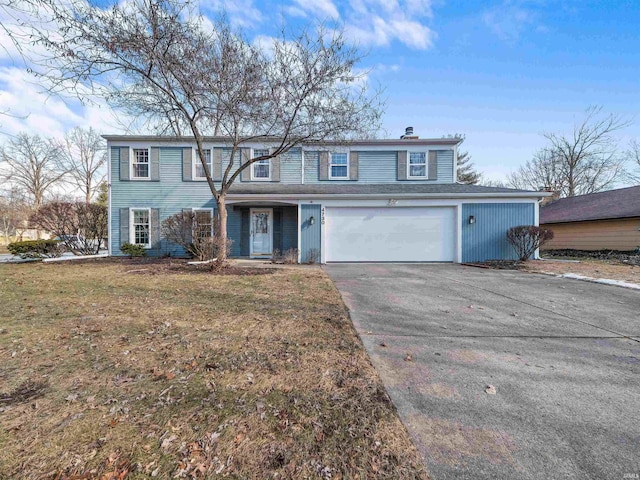 view of front property featuring a garage and a front lawn