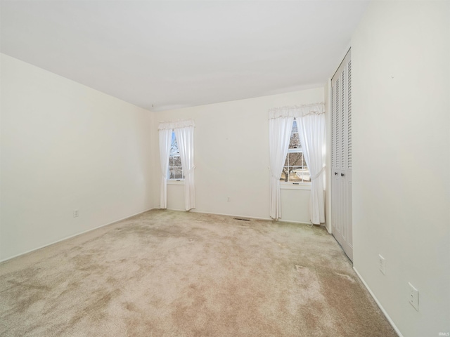 unfurnished room with light carpet