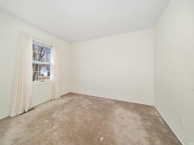 spare room featuring light colored carpet