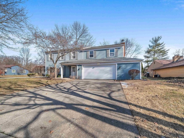 view of front of property with a garage and a front yard