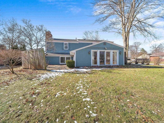 rear view of house featuring a yard