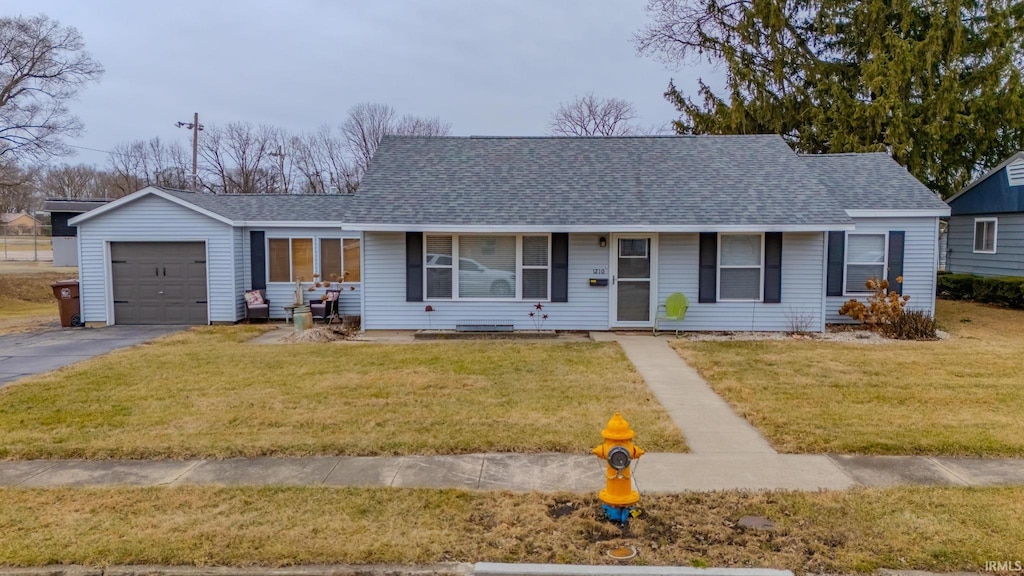 single story home with a garage and a front yard