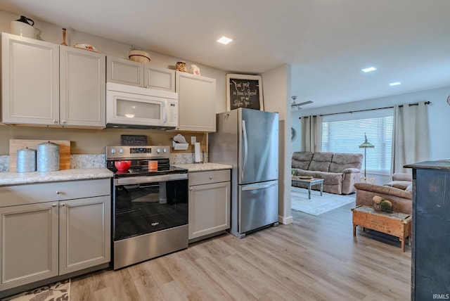 kitchen featuring light wood-type flooring and appliances with stainless steel finishes