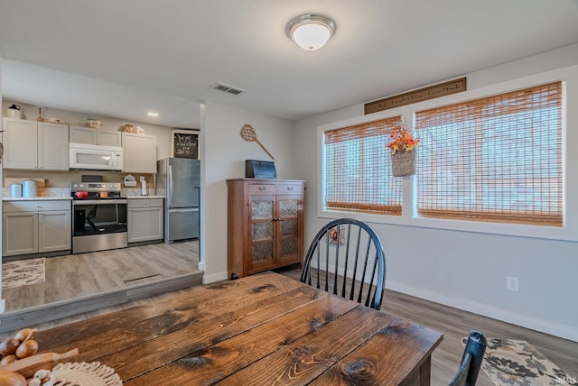 dining space with hardwood / wood-style floors