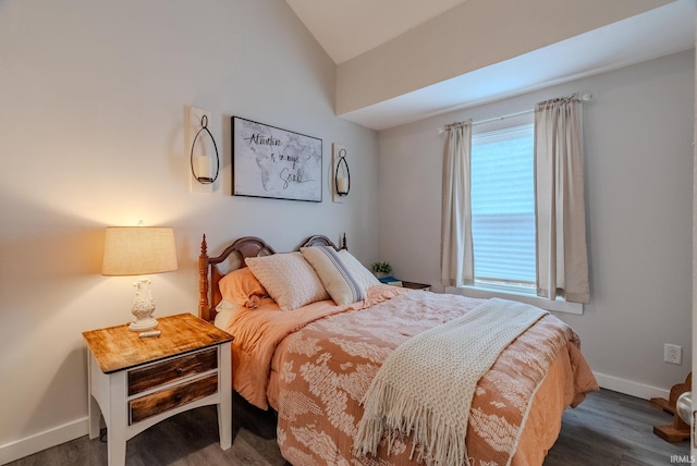 bedroom featuring dark wood-type flooring and lofted ceiling