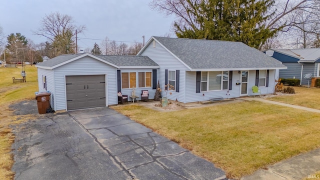 ranch-style home with a garage, covered porch, and a front lawn