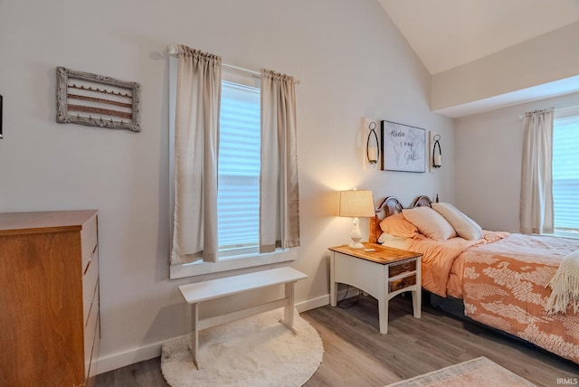 bedroom featuring lofted ceiling and light hardwood / wood-style floors